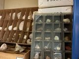 many boxes and bins on a shelf in a room