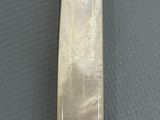 a silver and gold knife with a white handle