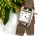 a watch that is sitting on top of a brown strap