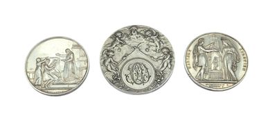 three different types of silver coins on a white surface
