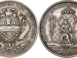 a close up of a silver coin with an image of a man on a horse