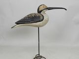 sculpture of a bird with a long beak on a metal stand