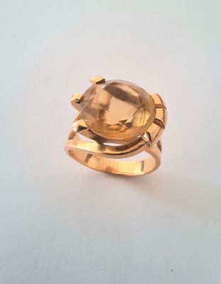 an image of a gold ring with a faceted citrine stone