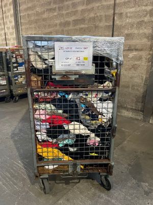 a metal cart with many items in it in a warehouse