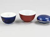 two small bowls and a small bowl on a white surface