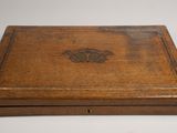 an old wooden box sitting on top of a white table