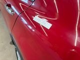 a red car with a sticker on the side of it