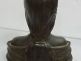 a statue of a woman that is sitting on top of a table