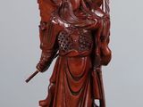 an image of a statue of an angel holding a sword on a table