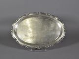 a silver plate with a decorative design on the rim