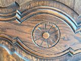 a close up of a wooden door with a clock on it