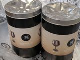 two tins of wine sitting on a plastic bag
