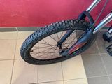 a bike that is sitting on the floor next to a red wall
