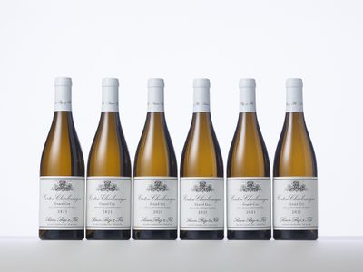 six bottles of white wine lined up in a row