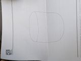 a person holding a piece of paper with a drawing on it
