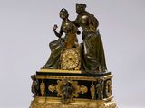 une image représentant une horloge en bronze avec une femme et un enfant