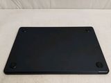 a black laptop computer sitting on top of a white couch