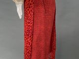 a red and black leopard print skirt with a white blouse on a mannequin mannequin mannequin mannequin mannequin mannequin mann