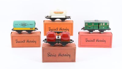 four toy trains sitting on top of boxes with names on them