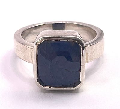 an image of a ring with a blue stone in it