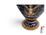 an image of a blue and orange vase with a man on it