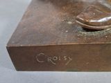 bronze statue of a man ' s feet on a box with a shoe