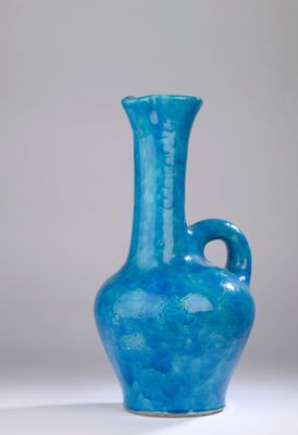 a blue vase that is sitting on a table