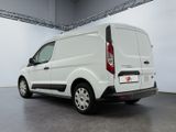 the rear of a white van is parked in a garage