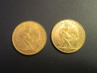 a close up of two gold coins on a black surface