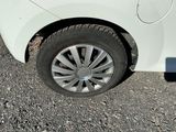 a white car that is parked on the side of the road