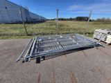 a pile of metal bars on the ground in front of a building