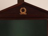 a clock that is sitting on a shelf in the room
