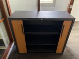 a black and wood cabinet with shelves in a room