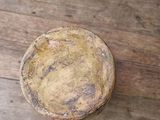 a small bowl on a wooden table with a black background