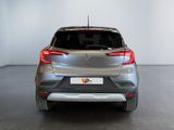 the rear end of a silver car in a white room