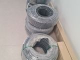 many rolls of wires on the floor in a room