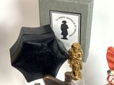 figurines are displayed on a table in front of a box