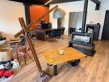 a living room with a wood burning stove and chairs