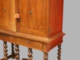 an old wooden cabinet with a door on top of it