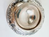 a silver plate with a decorative design on it