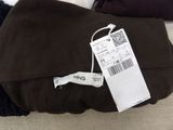 a tag on a pair of pants on a couch