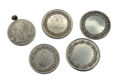 four different types of silver coins are shown on a white surface