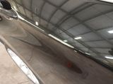 a close up of a car door with a reflection on it