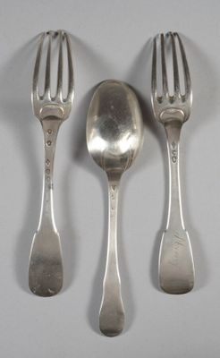three spoons and two forks on a table