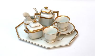 a picture of a white and gold tea set on a tray