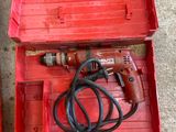 two red tools in a red case on the floor