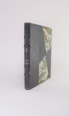 an old book sitting on top of a white table next to a white wall