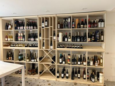 many bottles of wine on the shelves in this room