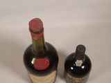 two bottles of wine sitting next to each other on a table
