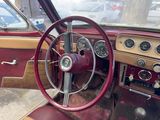 a steering wheel and dashboard of an old car